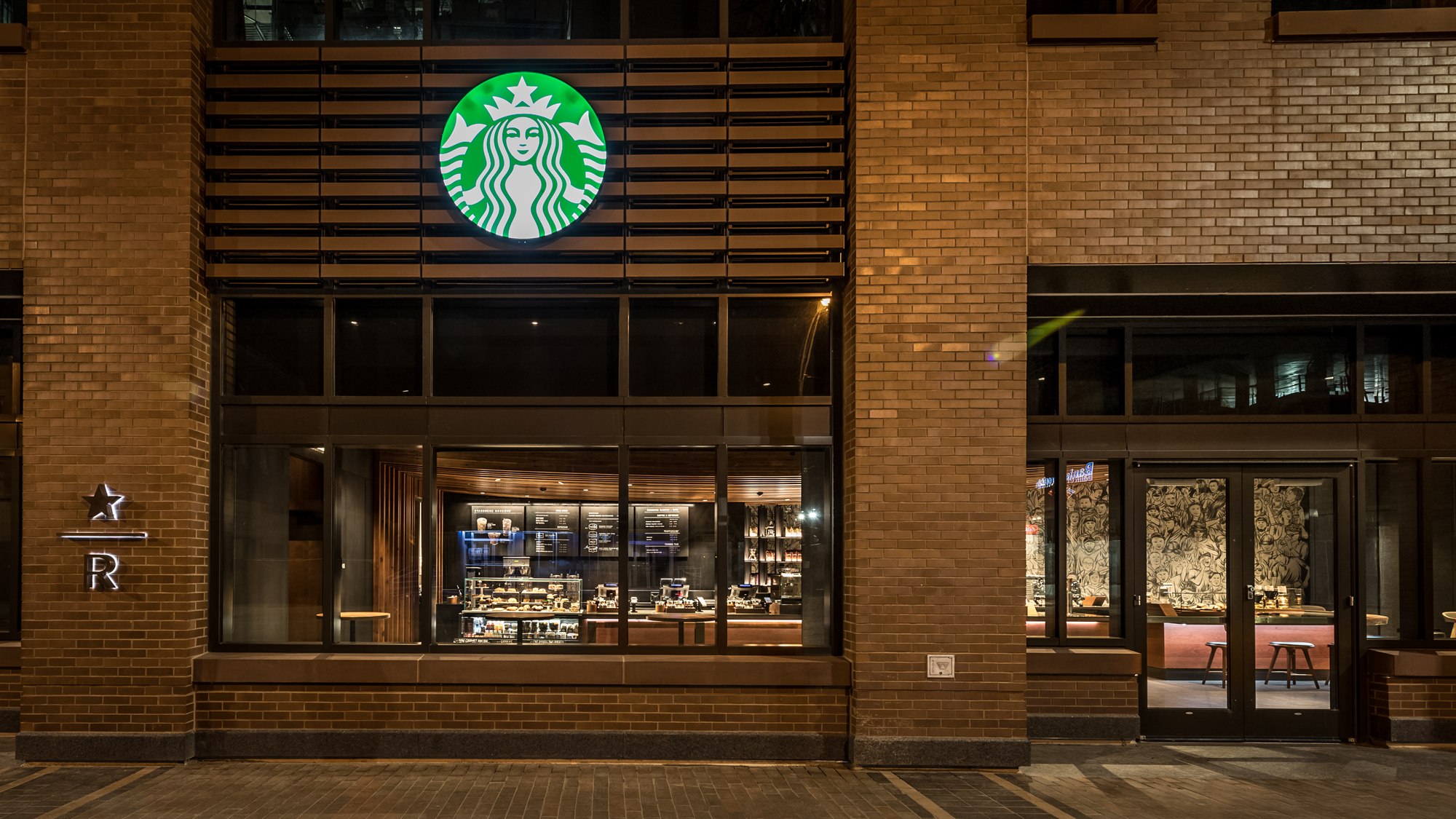 Starbucks Reserve storefront at The Park at Wrigley, Chicago, at night